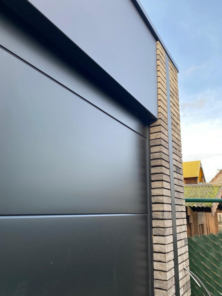 Garagepoort woning bij avond &mdash; woning De Kort, Kasterlee