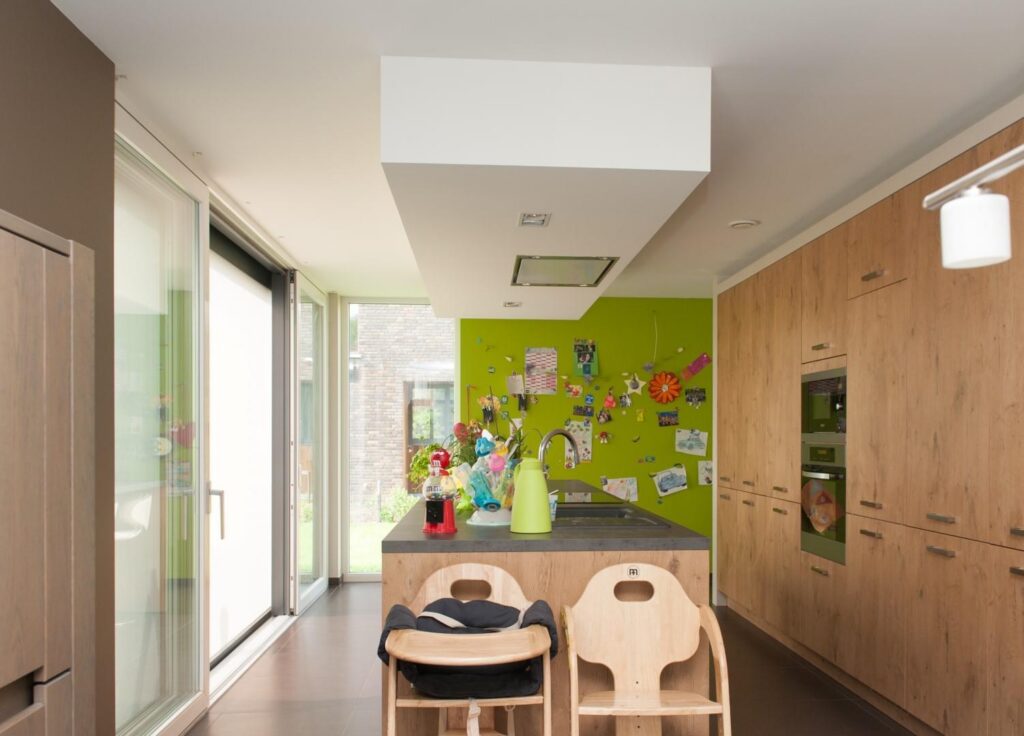 Leefruimte met groene muuraccent &mdash; woning De Wree, Vrasene